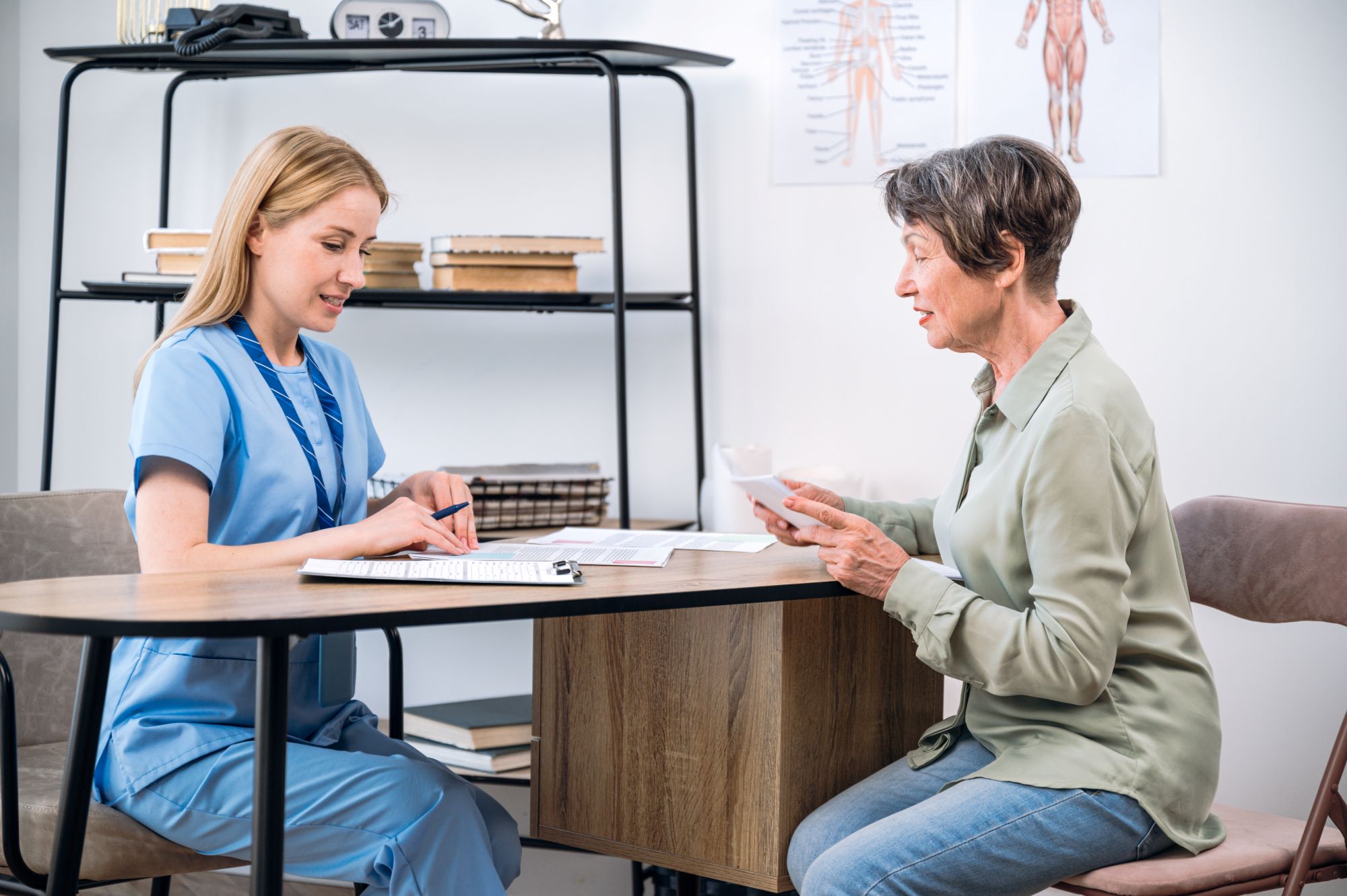 Doctor assists elder patient with medical and insurance documents